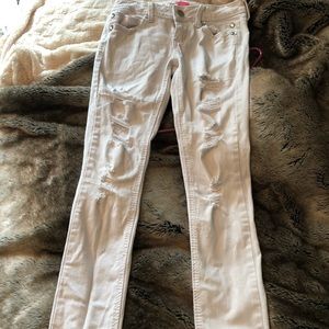 Distressed white skinny jeans